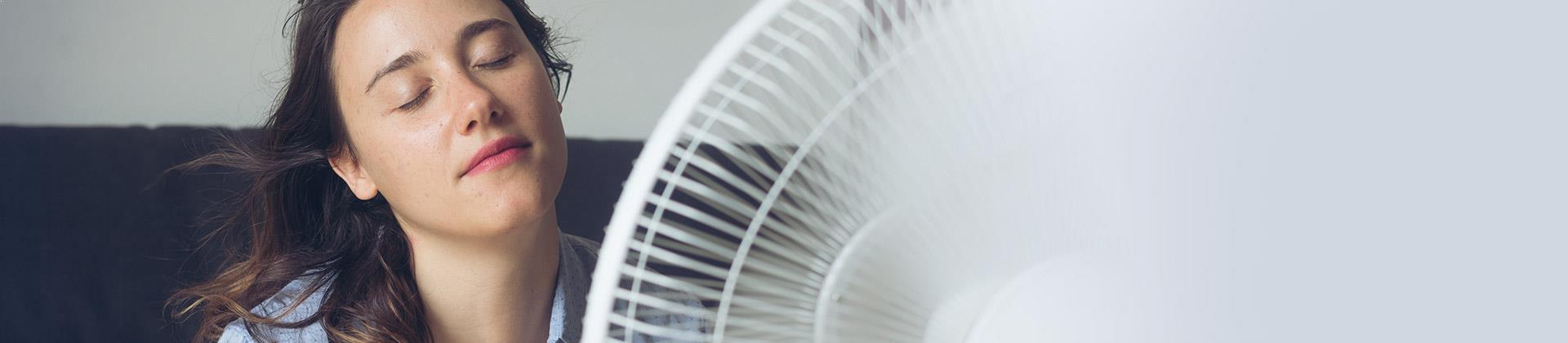lady cooling down with fan